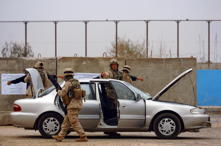 050220-N-6967M-138 Ramadi, Iraq (Feb. 20, 2005) Ð U.S. Marines and Sailors, assigned to 1st Marine Division, 2nd Battalion, 5th Marines, search Iraqi vehicles and their occupants at a Ramadi, Iraq checkpoint. Marines and Sailors are currently conducting Operation River Blitz to limit the movement of insurgents by use of checkpoints in vital entry points to the city. U.S. Navy photo by Photographer's Mate 1st Class Shane T. McCoy (RELEASED)